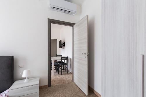 a bedroom with a mirror and a table with a chair at Bilocale Noverasco IEO 3 in Opera