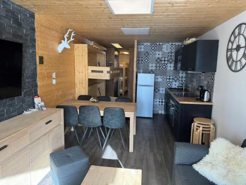 a kitchen and living room with a table and chairs at Appartement Tignes Val claret in Tignes