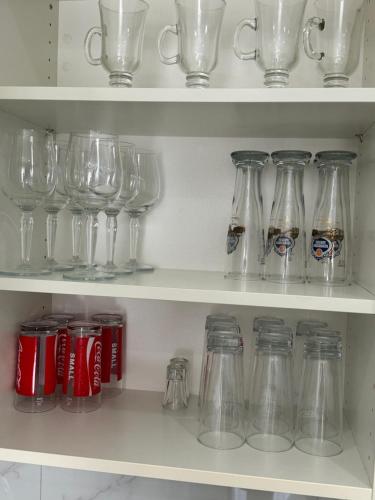 a bunch of glass jars and bottles on a shelf at Apartments Funtana with pool in Funtana