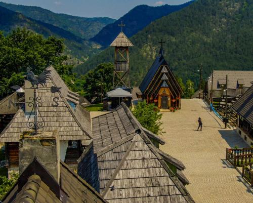 a person standing on a roof of a building at Mecavnik Resort in Mokra Gora
