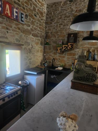 a kitchen with a counter top and a stove top oven at Bulle perchée in Sonnac-sur-lʼHers
