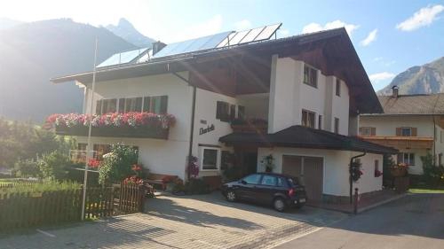 a house with a car parked in front of it at Haus Charlotte in Kals am Großglockner