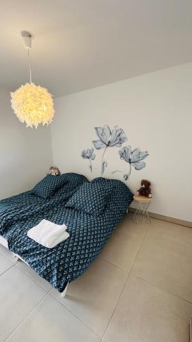 une chambre avec un lit avec une couette bleue dans l'établissement L'échappée, à Bandol