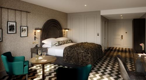 a hotel room with a bed and a table and chairs at Hotel Gotham Newcastle in Newcastle upon Tyne