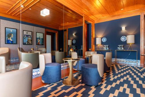 a lobby with blue and white furniture and wood ceilings at Palácio do Governador - Lisbon Hotel & Spa in Lisbon