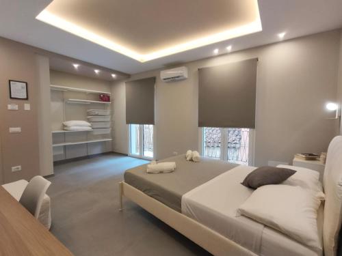 a large bedroom with a large bed and a table at Luma Casa Vacanze Castelbuono in Castelbuono