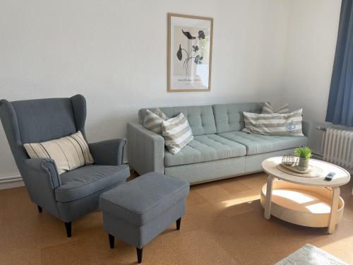 a living room with a couch and a chair at Küstenbude Strandbude in Grömitz
