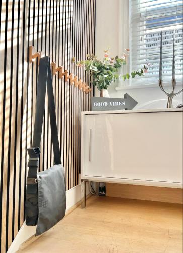a white table with a plant on it next to a window at Stunning Central London flat 1 min Bond Street in London