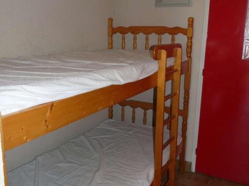 une chambre avec un lit superposé avec des draps blancs dans l'établissement Studio cabine 4 pers - Plage à 50m - Parking privé - FR-1-328-89, à La Grande Motte