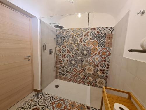 a bathroom with a shower with a mosaic wall at Frally's dream in Catania