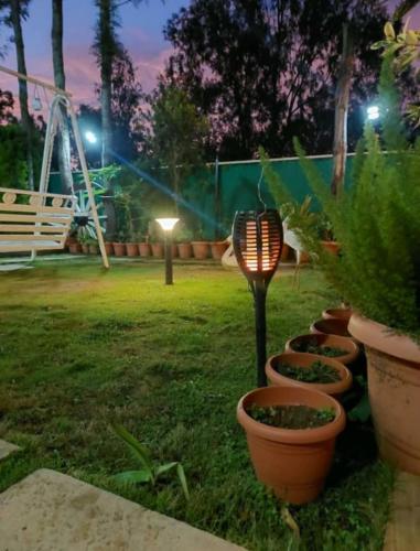 a light in a yard with a park at night at Tigerwoods Cottage in Chikmagalūr