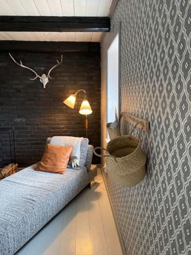 a bedroom with a bed and a wall at Cottage 1909- Close to Helsingborg in Helsingborg