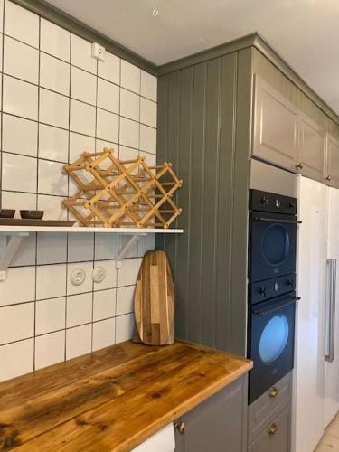 a kitchen with a wooden counter top and a dishwasher at Cottage 1909- Close to Helsingborg in Helsingborg
