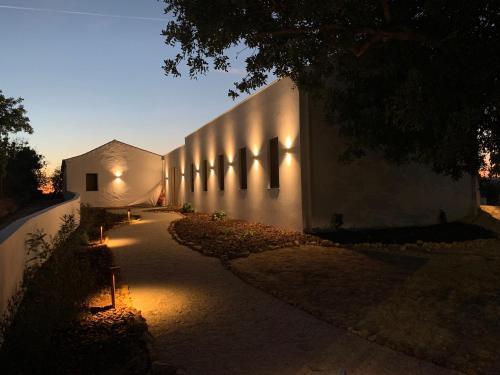 a building with lights on the side of it at B&B Quinta a Fonte Tavira - Adults Only in Tavira