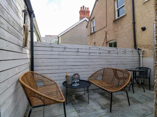 two chairs and a table on a patio at Elsinore in Conwy