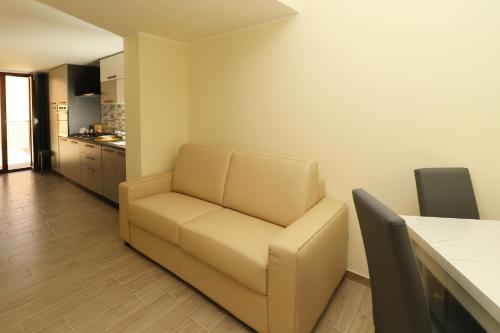 a living room with a couch and a kitchen at Like Home in Nocera Superiore