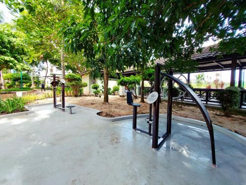 a water slide in a park with trees at Good2Stay Apartment 6-8pax l 3R2B l 2 Parking l Coway Water l Unifi I Swimming Pool in Melaka