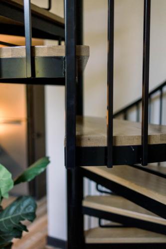 a metal staircase in a room with a plant at A Frame of Mind in Dahlonega