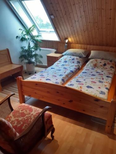 a bedroom with a large bed and a chair at Ferienwohnung JAGODA in der Lüneburger Heide in Frankenfeld