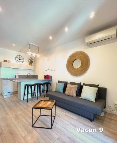 a living room with a couch and a table at Les Appartements du Vieux Port in Marseille