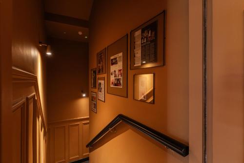 a hallway with a staircase with pictures on the wall at Number 59 Dublin in Dublin
