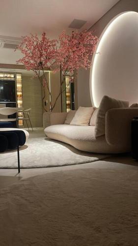 a living room with a couch and a large mirror at Studio LUA home Batel - Luxo e Conforto no coração de Curitiba! in Curitiba