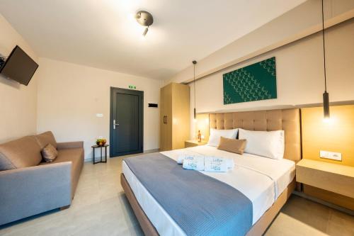 a bedroom with a large bed and a couch at Lofos Luxury Living in Stavros