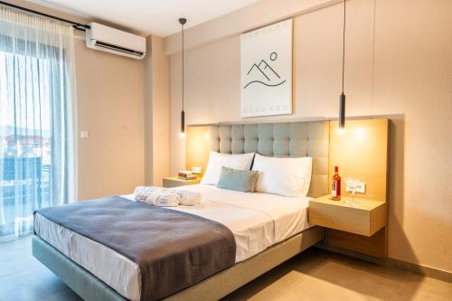 a bedroom with a bed with two towels on it at Lofos Luxury Living in Stavros