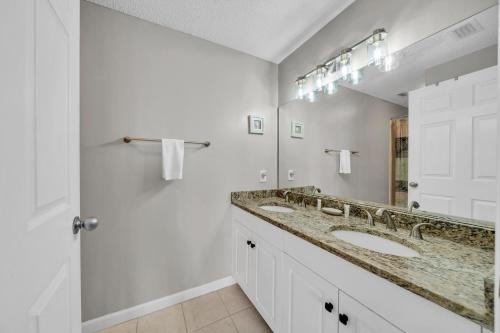 a bathroom with two sinks and a mirror at Majestic Sun 0303A in Destin