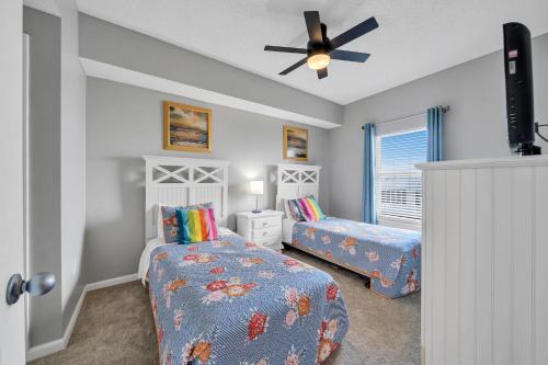 a bedroom with two beds and a ceiling fan at Majestic Sun 0303A in Destin