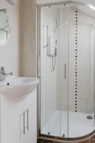 a bathroom with a sink and a shower at Joe's Corner House in Shanagarry