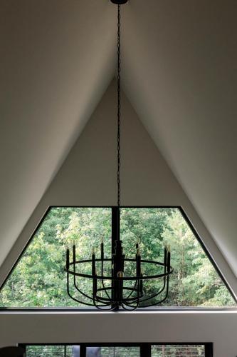 a chandelier hanging in a room with a window at A Frame of Mind in Dahlonega