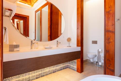 a bathroom with a sink and a mirror at Palácio do Governador - Lisbon Hotel & Spa in Lisbon