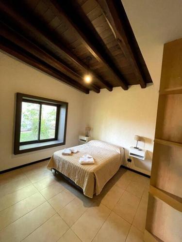 a bedroom with a bed and a large window at Comarca Andina in Ciudad Lujan de Cuyo