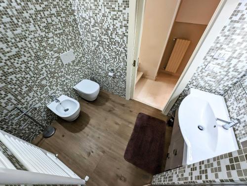 a bathroom with a sink and a toilet in it at Oikia Vacanze Diso Giulia in Diso