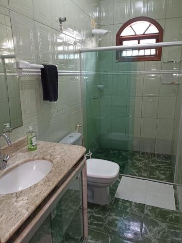 a bathroom with a toilet and a sink and a shower at Big House in Prado