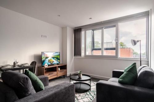 a living room with two couches and a large window at 1 Bed Modern Central Preston Apartment in Preston