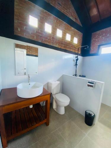 a bathroom with a sink and a toilet at ARISTA Homestay in Tetebatu