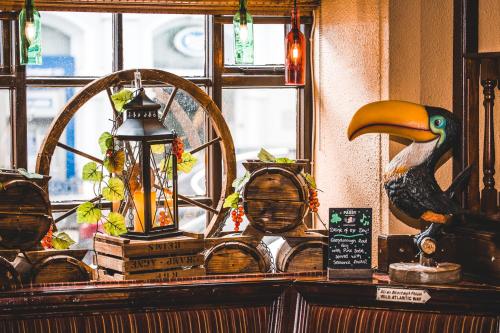 a table with a bird and a lamp and a window at The Dingle Pub Rooms in Dingle