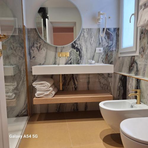 a bathroom with a sink and a mirror at Hotel Maxim Axial in Florence