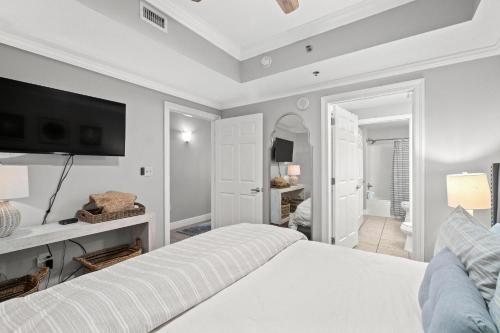 a bedroom with a bed and a tv on the wall at Ariel Dunes II 1106 in Destin