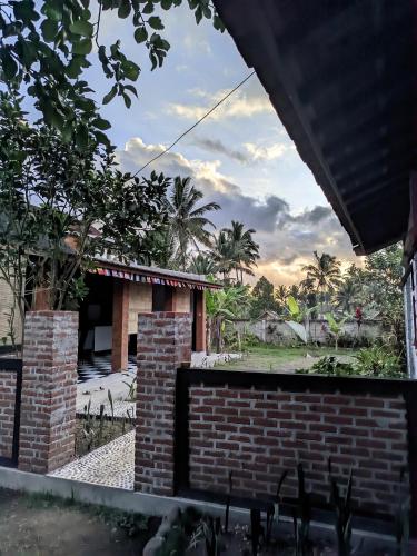 a view of a house with a brick wall at ARISTA Homestay in Tetebatu