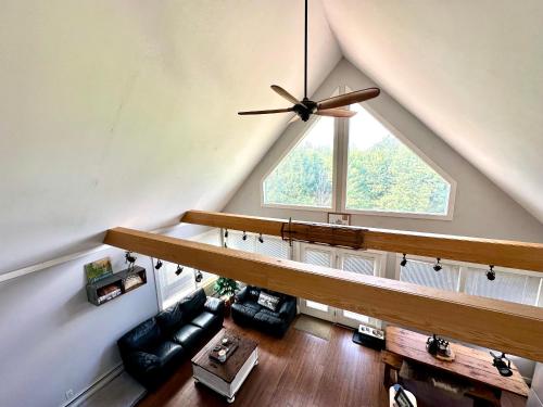 a living room with a ceiling with a large window at Journeys End Chalet - Minutes to Jay Peak! in Jay