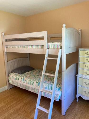 a bedroom with two bunk beds and a ladder at The Buoys in Gloucester