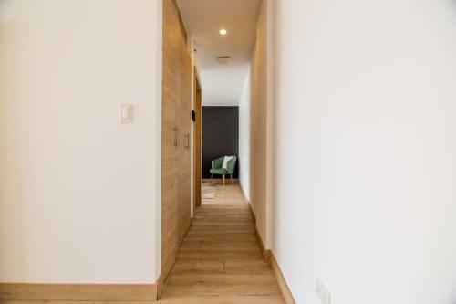 a hallway with white walls and wooden floors at Alba Gallery Suite in Quito