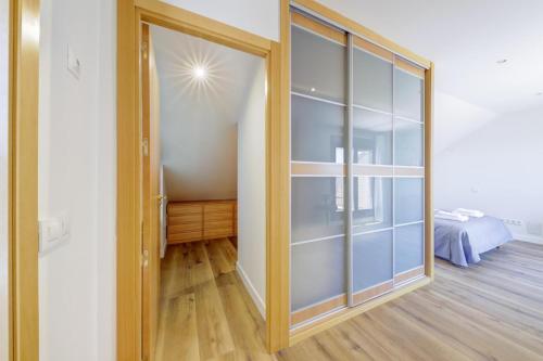 a sliding glass door in a room with a bedroom at El Palomar in Madrid