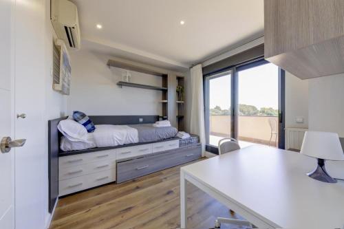 a bedroom with a bed and a desk in a room at El Palomar in Madrid