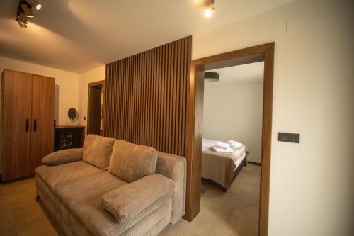 a living room with a couch and a bed at Cantina rooms in Hum na Sutli
