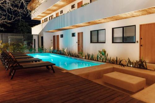 a swimming pool in the middle of a house at Cozy apartment with pool in Bacalar Center in Bacalar