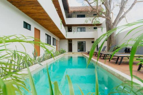 a swimming pool in the backyard of a house at Cozy apartment with pool in Bacalar Center in Bacalar